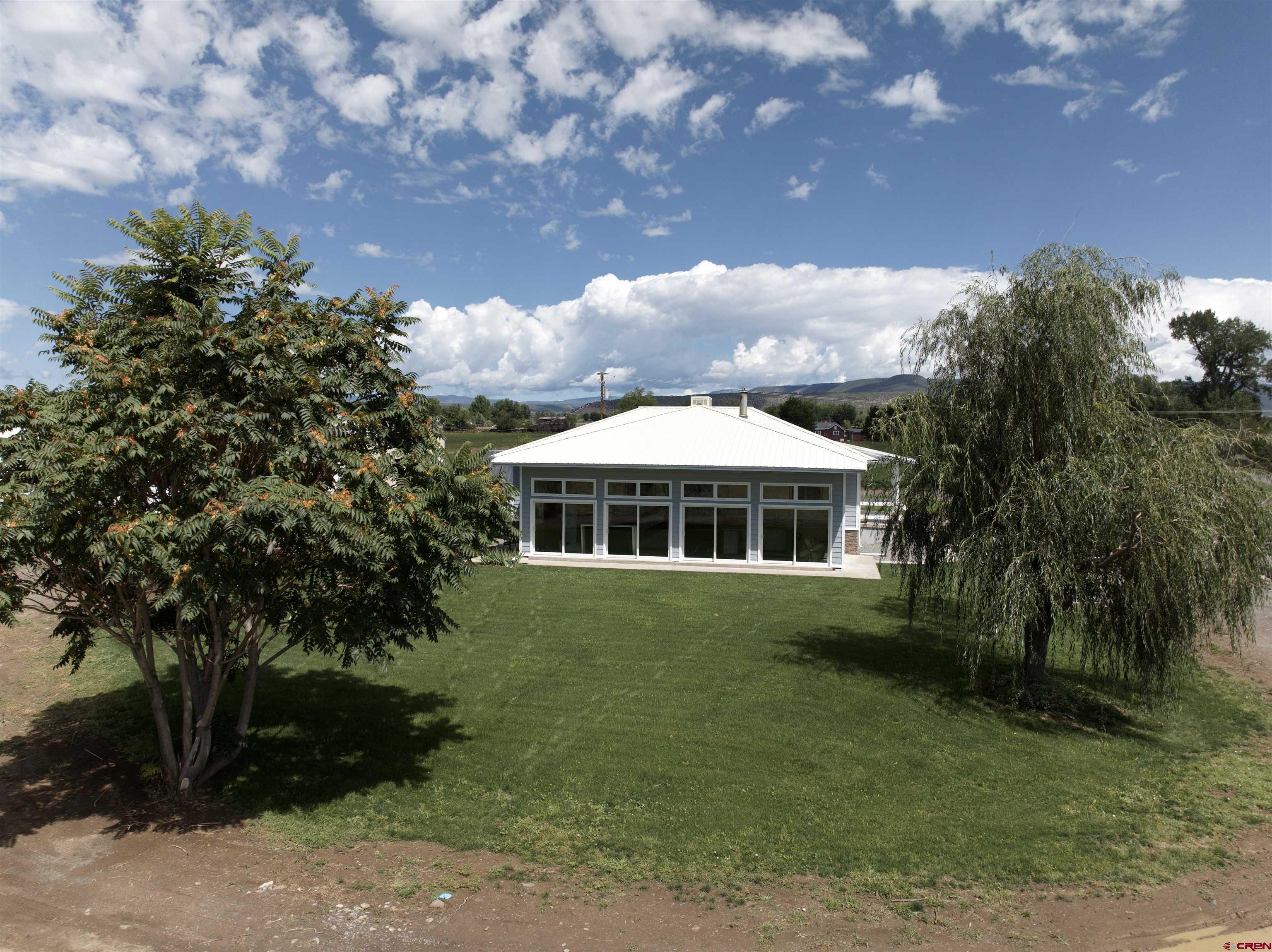 9627 3200th Road Hotchkiss, CO 81419 - Photo 6 of 44 a front view of a house with garden