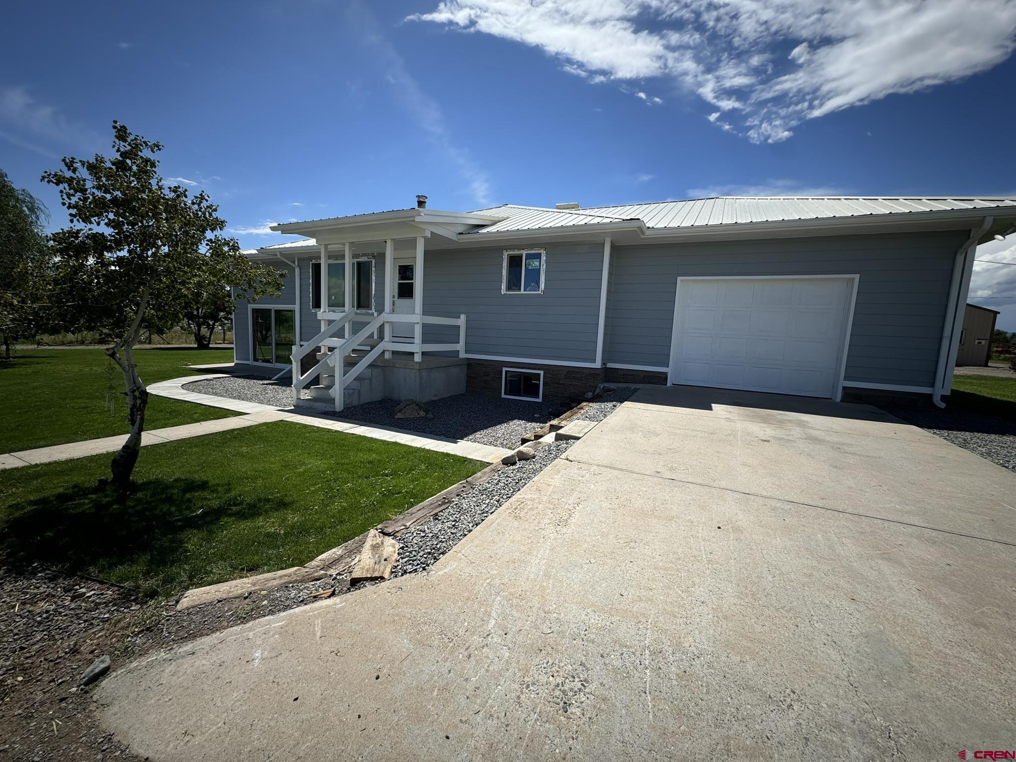 9627 3200th Road Hotchkiss, CO 81419 - Photo 7 of 44 a front view of a house with a yard and porch