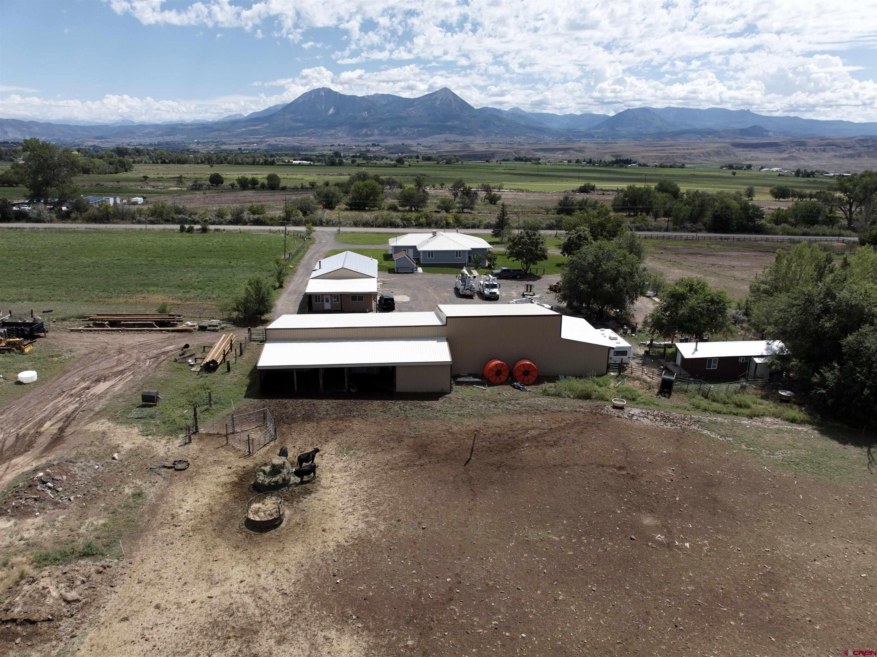 9627 3200th Road Hotchkiss, CO 81419 - Photo 10 of 44 an aerial view of a house with a garden and mountain view