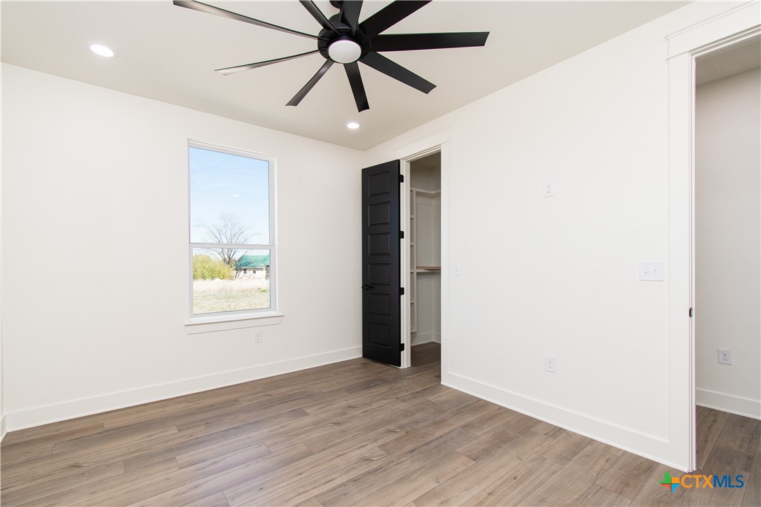 4245 Stringtown Road Temple, TX 76501 - Photo 17 of 25 an empty room with wooden floor and windows