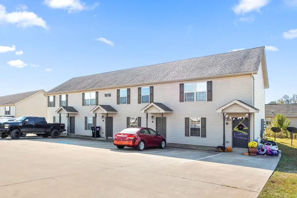 a view of a car park in front of house