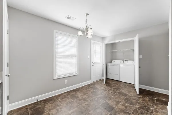 a view of a room with a windows and ceiling fan