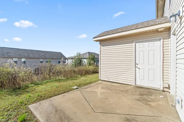a view of a house with a yard and garage