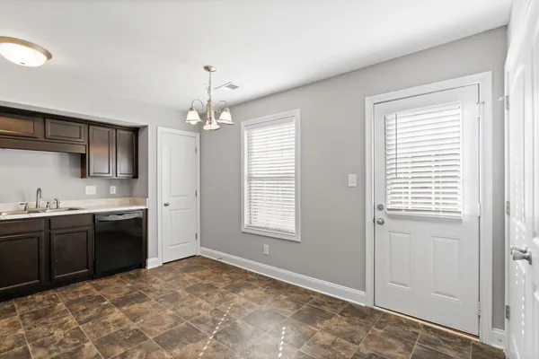 a kitchen with stainless steel appliances granite countertop a stove sink and cabinets