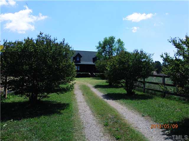 8724 Flower Hill Road Middlesex, NC 27557 - Photo 6 of 25 Winding drive flanked by crepe myrtles