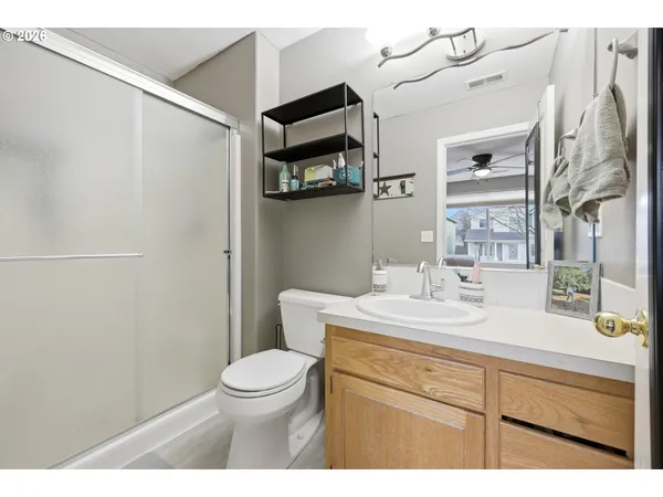 a bathroom with a granite countertop sink a toilet and a mirror