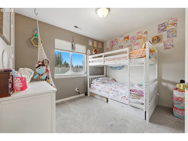 a bedroom with a bed and a white cabinet