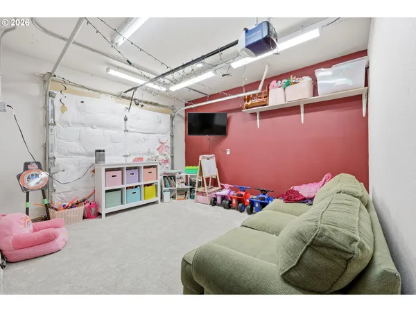 a bedroom with furniture and a flat screen tv