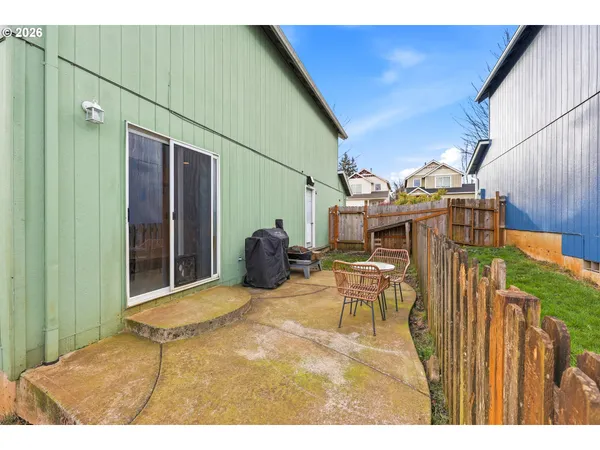 a view of a patio with table and chairs