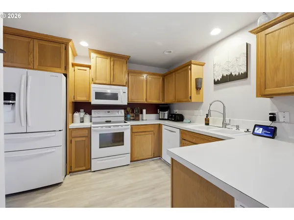 a kitchen with granite countertop a sink stainless steel appliances and cabinets
