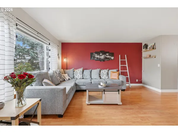 a living room with furniture chandelier and a large window