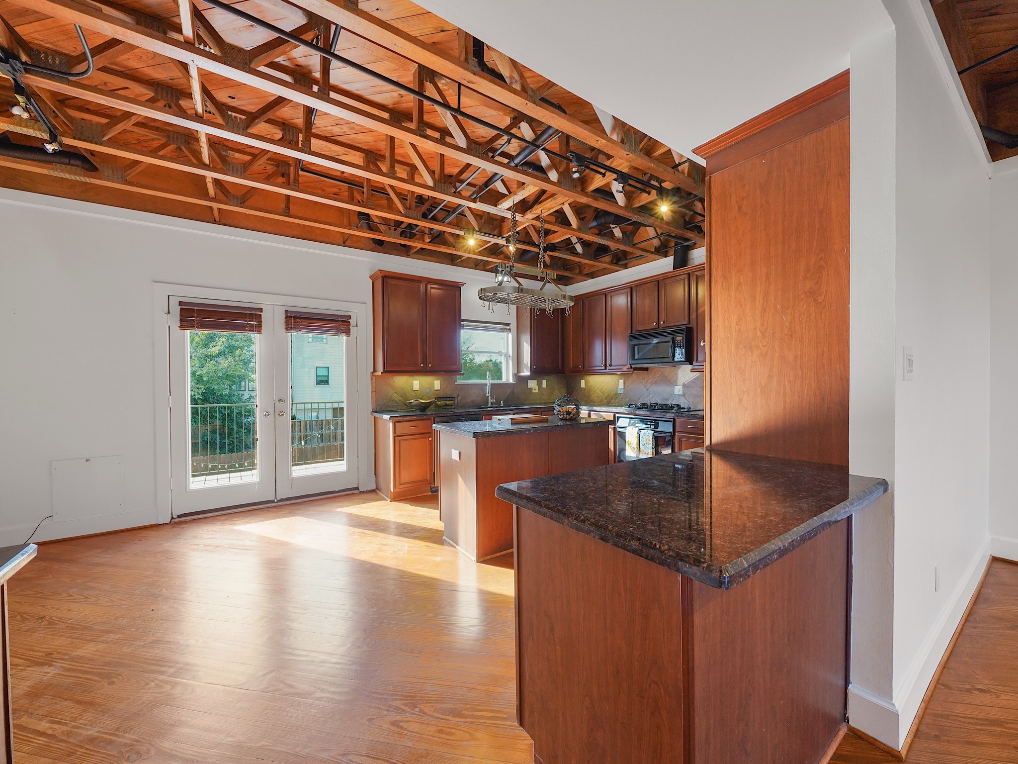 907 Hartman Street Houston, TX 77007 - Photo 15 of 34 a kitchen with stainless steel appliances granite countertop a sink a stove and a wooden floors