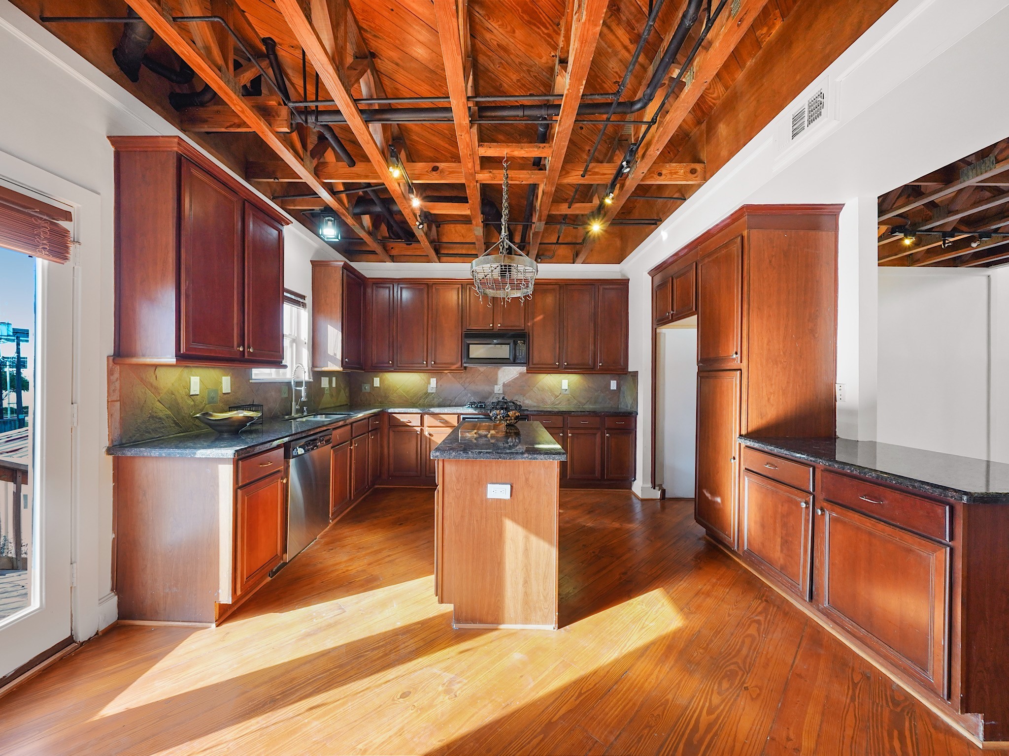 907 Hartman Street Houston, TX 77007 - Photo 16 of 34 a kitchen with stainless steel appliances granite countertop a sink a counter space and cabinets