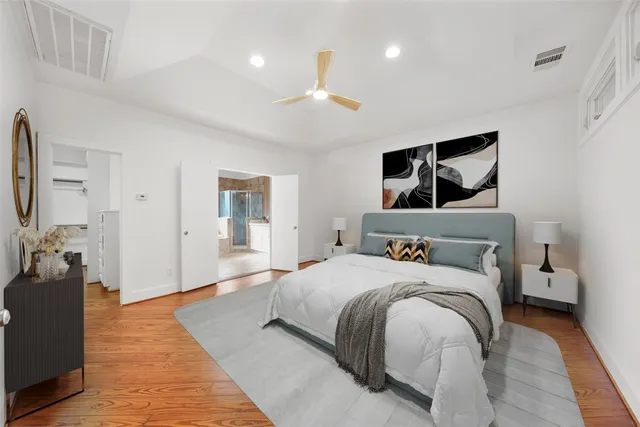 a bedroom with a large bed and a chandelier