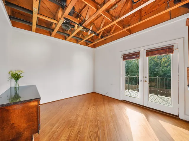 a view of room with wooden floor and potted plant