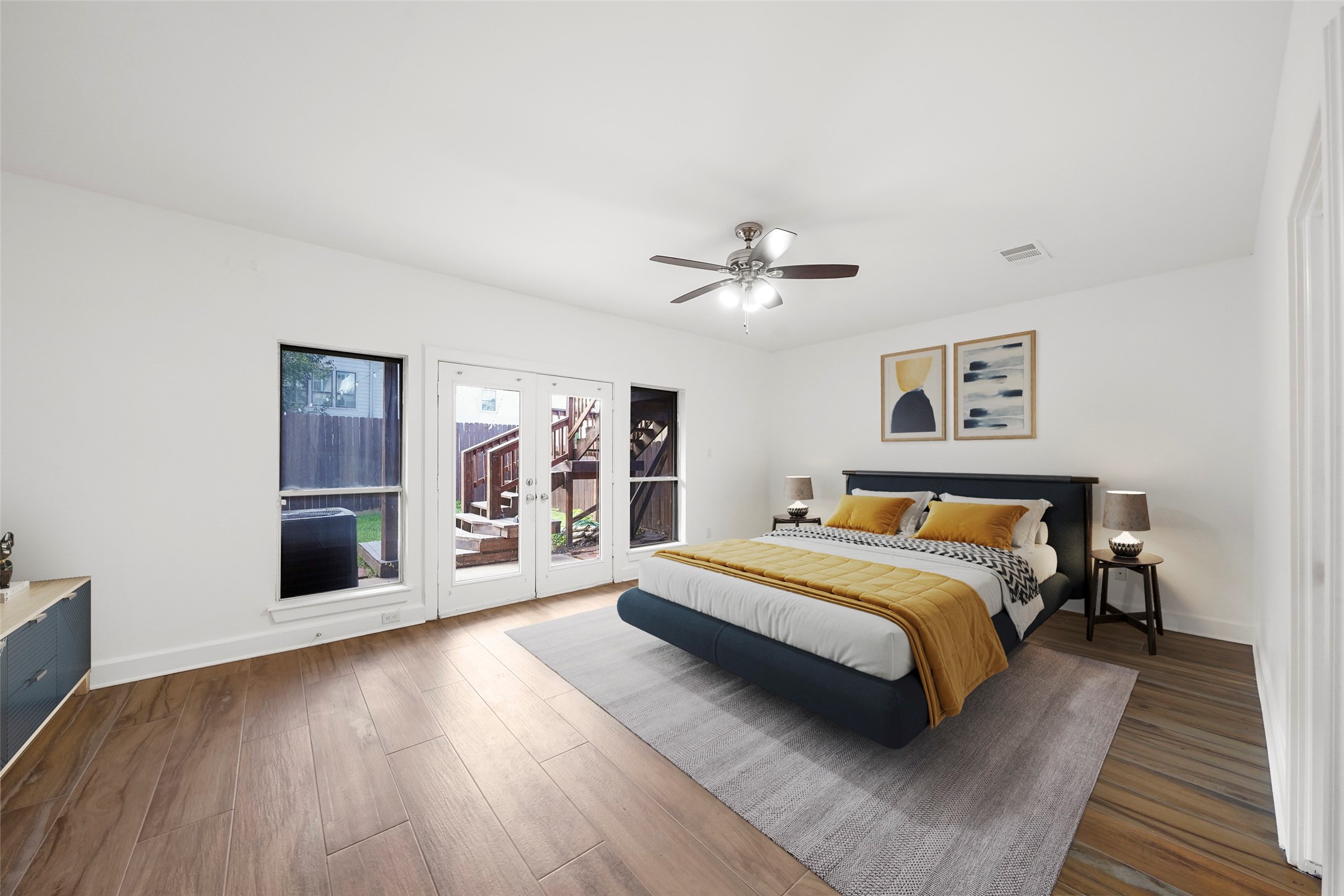 907 Hartman Street Houston, TX 77007 - Photo 2 of 34 a spacious bedroom with a large bed and a chandelier