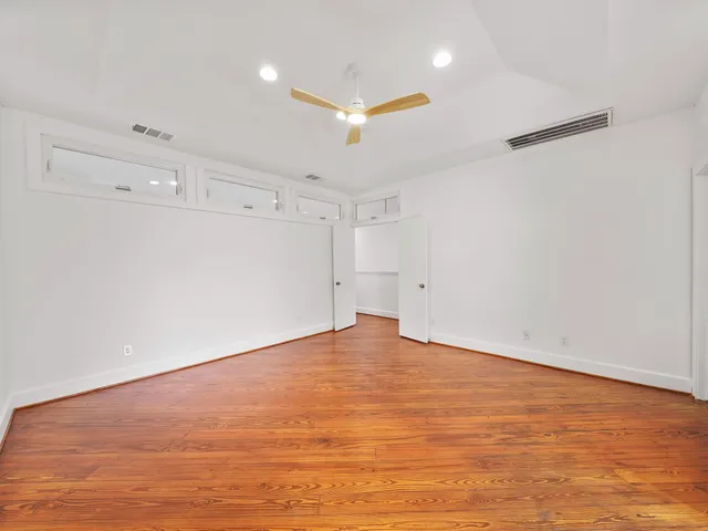 an empty room with an empty space and wooden floor