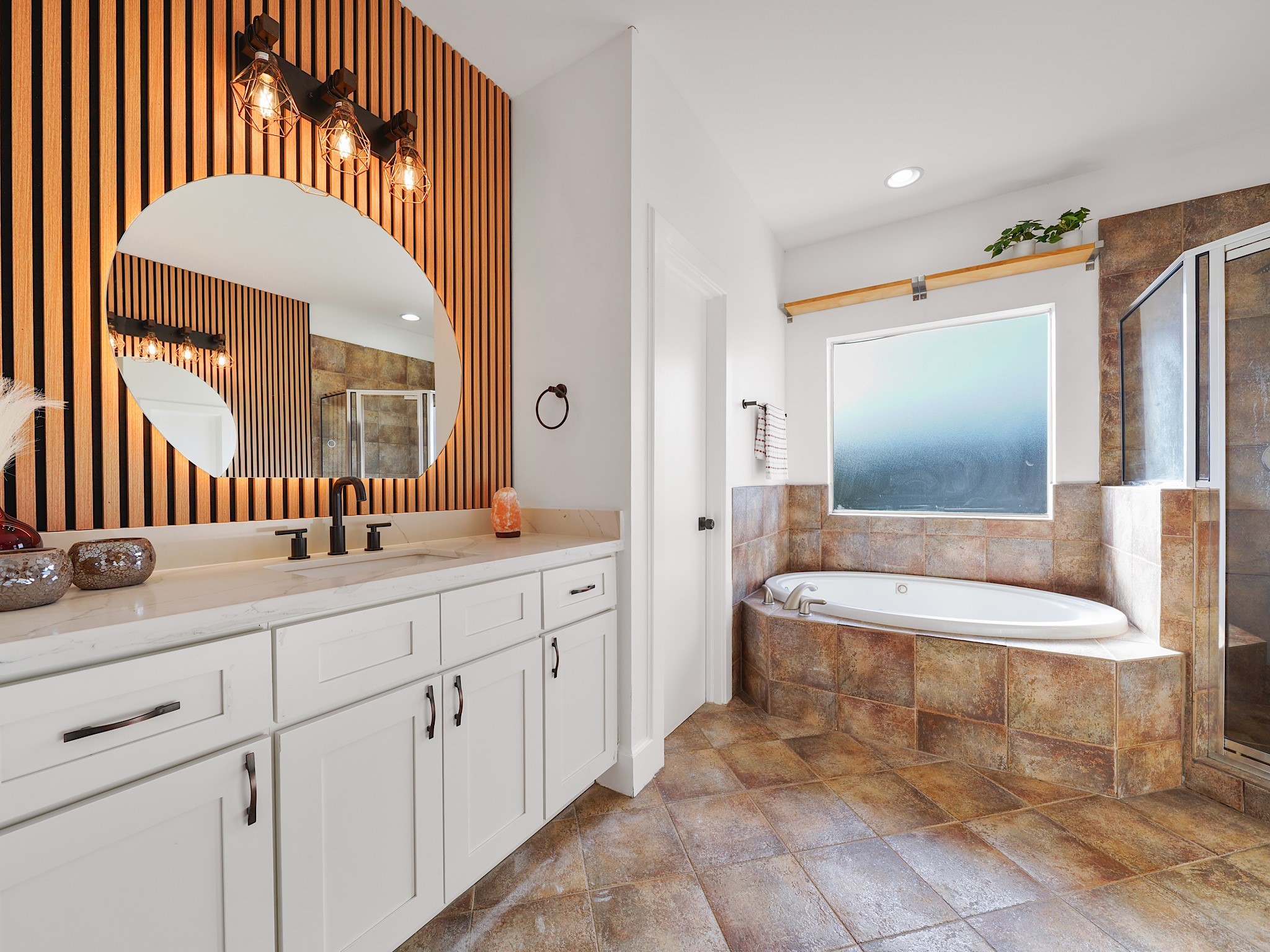 907 Hartman Street Houston, TX 77007 - Photo 27 of 34 a spacious bathroom with a double vanity sink a mirror and a bathtub