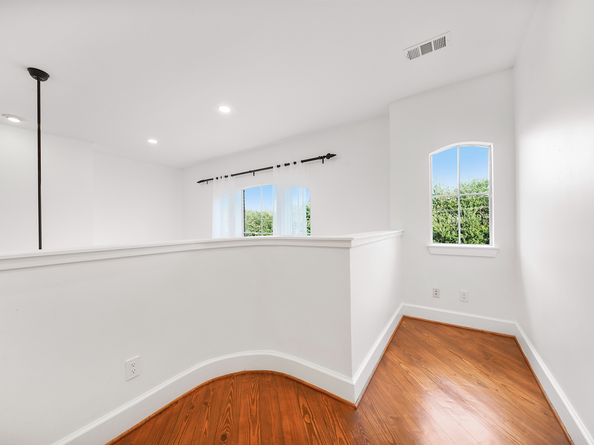 907 Hartman Street Houston, TX 77007 - Photo 31 of 34 a view of an empty room with window and wooden floor