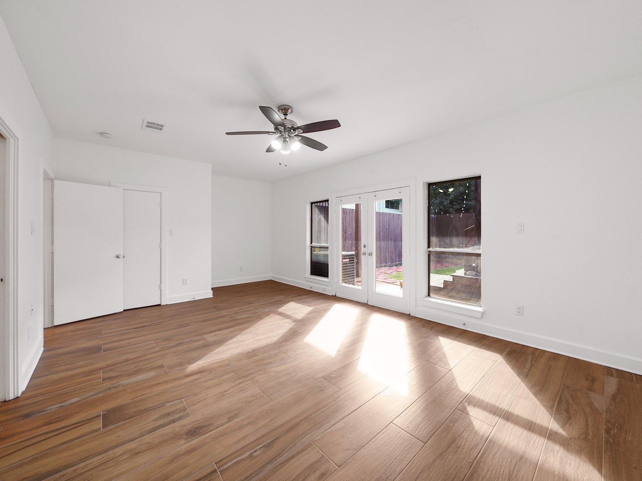 907 Hartman Street Houston, TX 77007 - Photo 4 of 34 a view of an empty room with a window and wooden floor