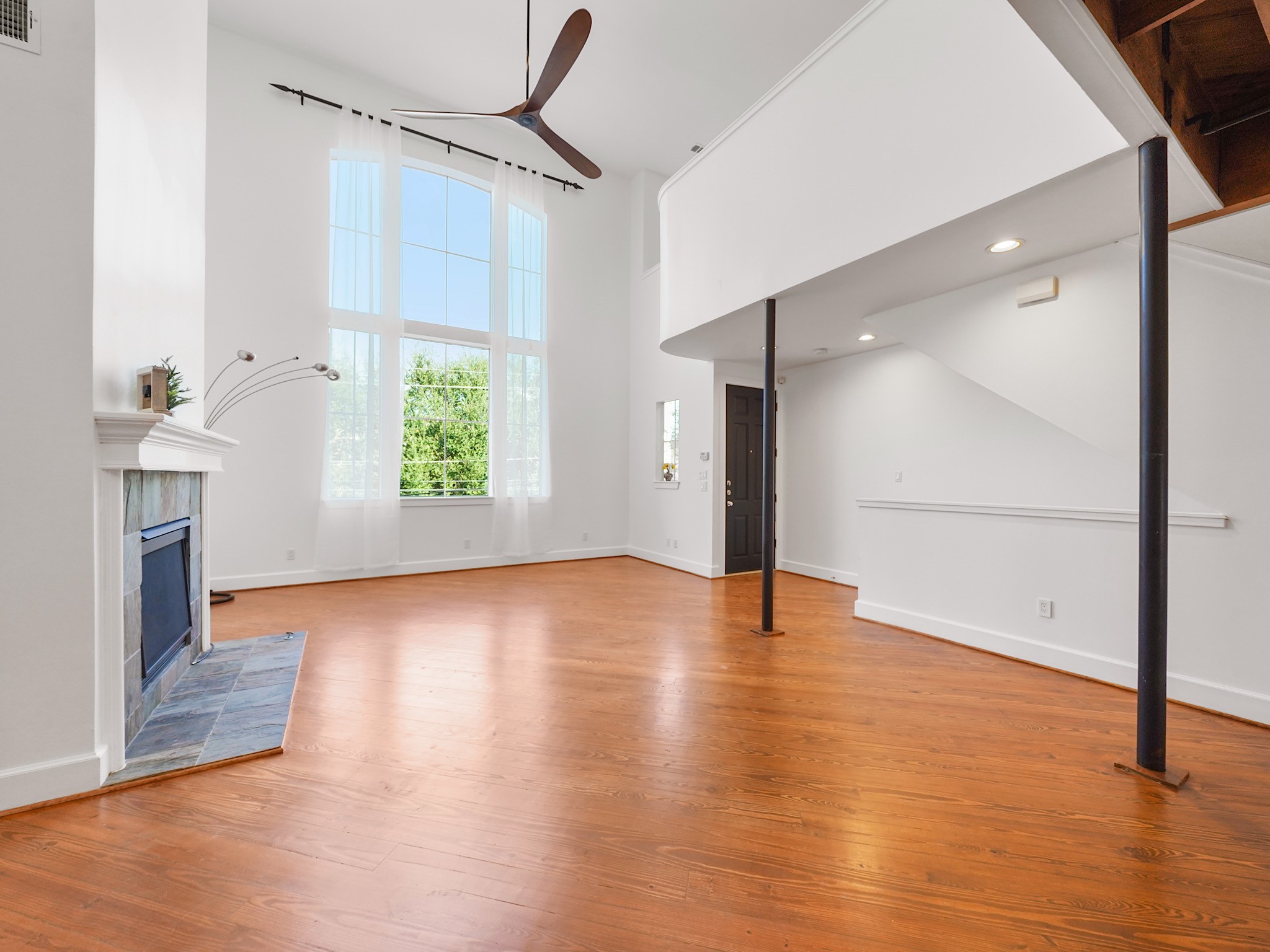 907 Hartman Street Houston, TX 77007 - Photo 10 of 34 a view of an empty room with window and wooden floor