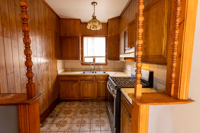 a kitchen with a sink stove and cabinets