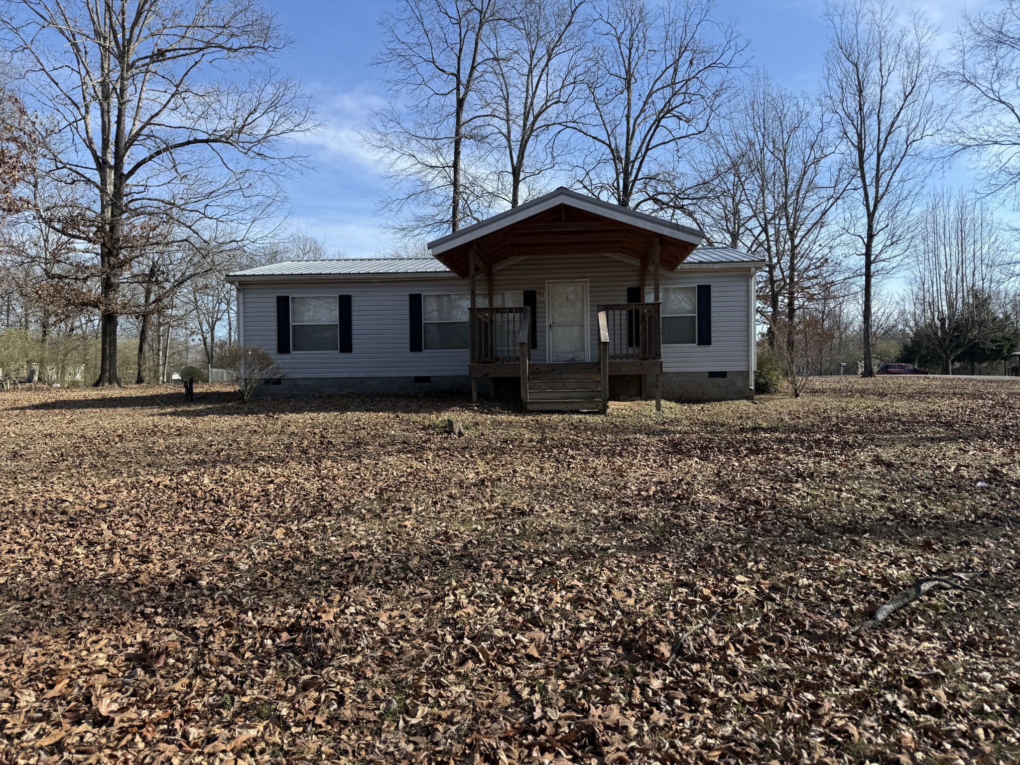 213 Alps Drive Hohenwald, TN 38462 - Photo 2 of 17 a front view of a house with garden