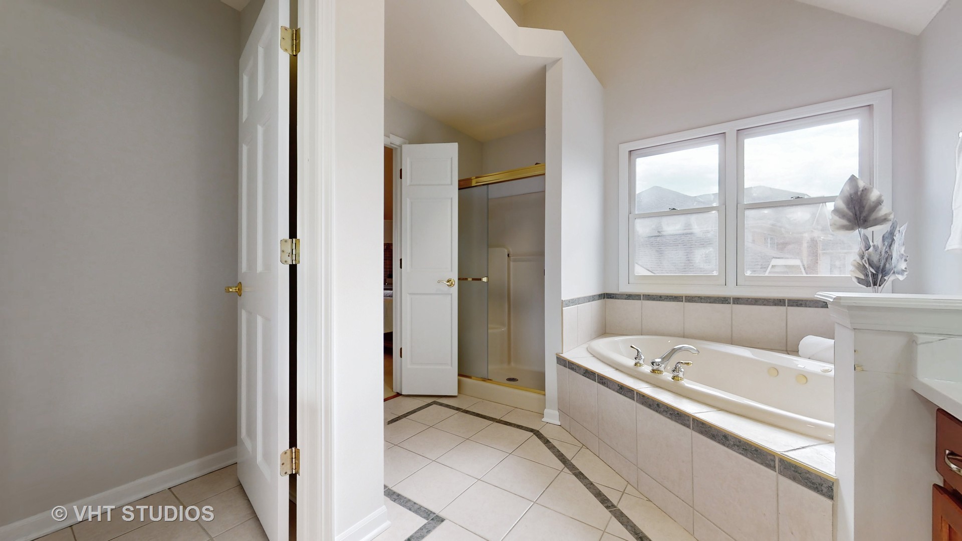 724 Sigmund Road Naperville, IL 60563 - Photo 26 of 44 a bathroom with a tub a sink and a window