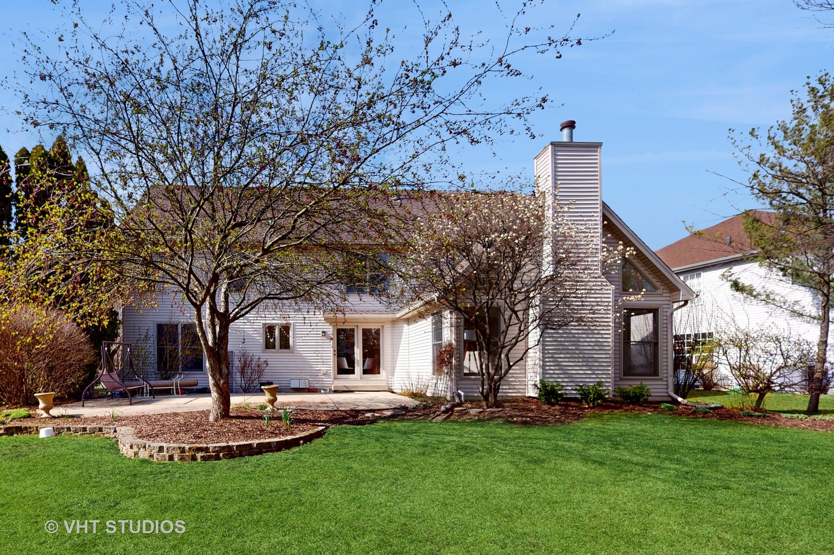 724 Sigmund Road Naperville, IL 60563 - Photo 39 of 44 a front view of a house with a garden and trees