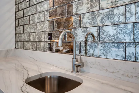 a spacious en suite bathroom with double sink and a mirror