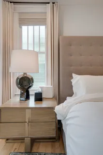 a bedroom with a large bed and a window