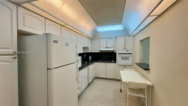 a kitchen with stainless steel appliances a refrigerator and a stove