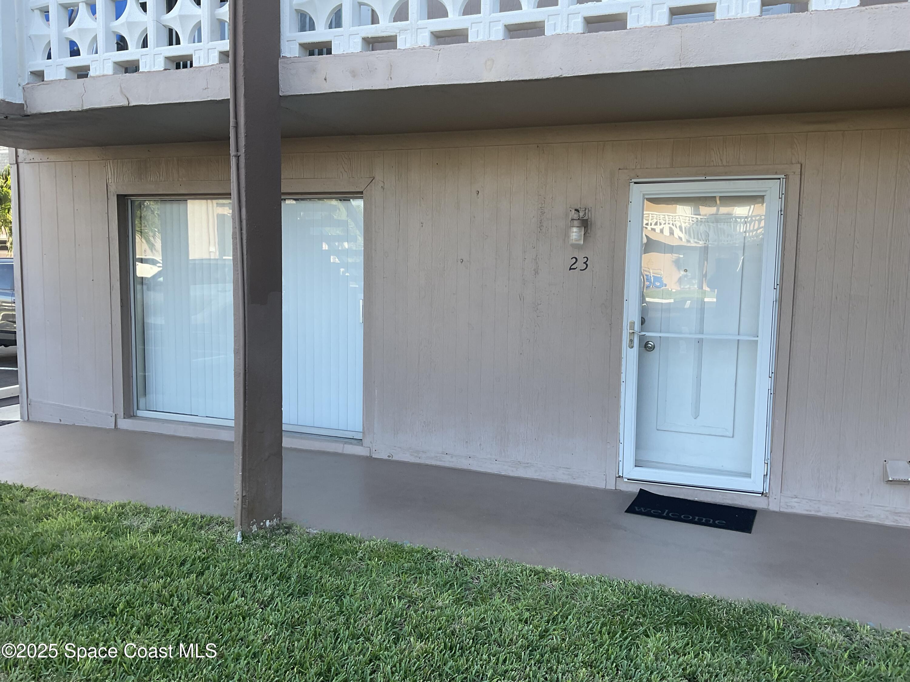 3150 North Atlantic Avenue, Unit 23330 Cocoa Beach, FL 32931 - Photo 17 of 18 an empty room with a door