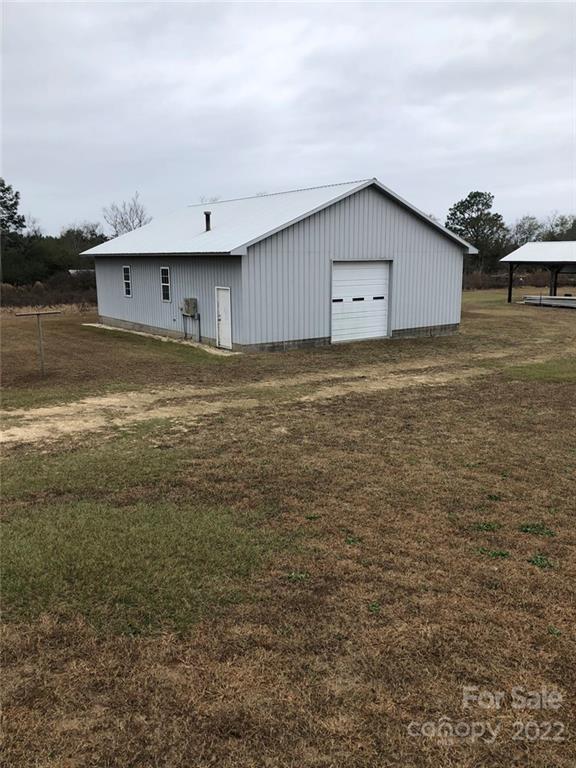 305 McCall Road Ellerbe, NC 28338 - Photo 12 of 14 a view of a house with a backyard
