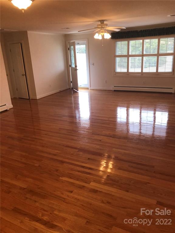 305 McCall Road Ellerbe, NC 28338 - Photo 2 of 14 a view of empty room with wooden floor and fan
