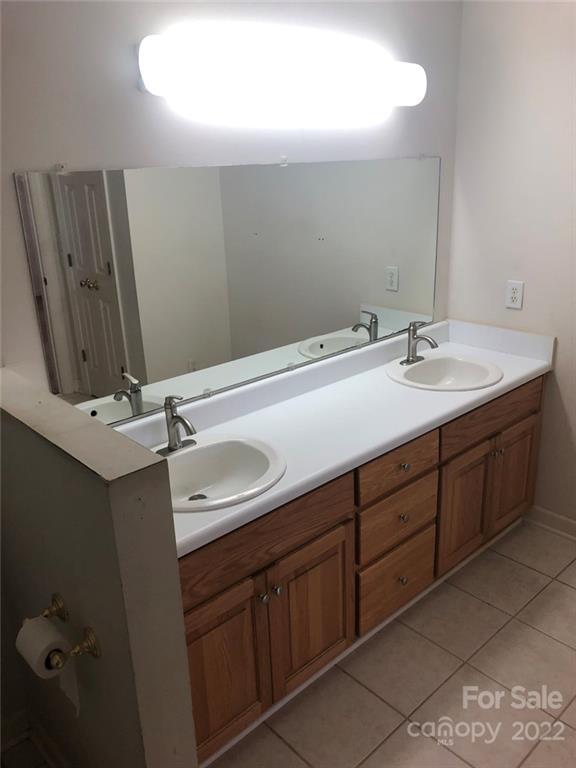 305 McCall Road Ellerbe, NC 28338 - Photo 10 of 14 a bathroom with a double vanity sink and mirror