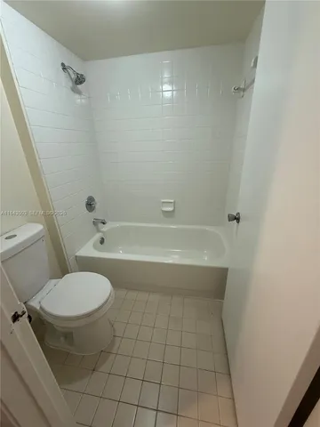 a bathroom with a bathtub and a toilet