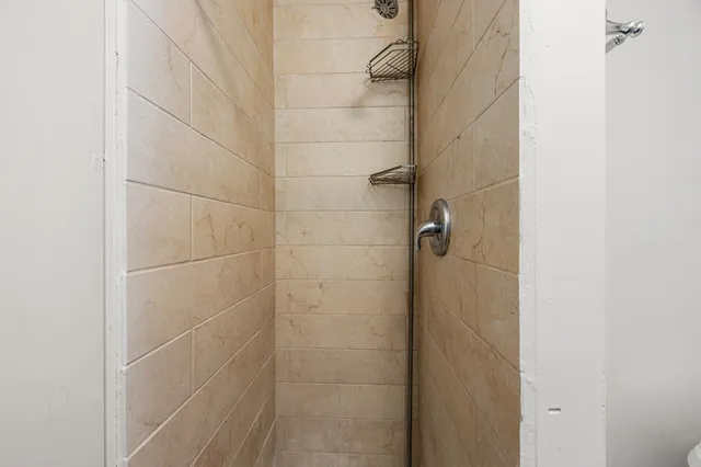 an empty room with wooden floor and cabinet
