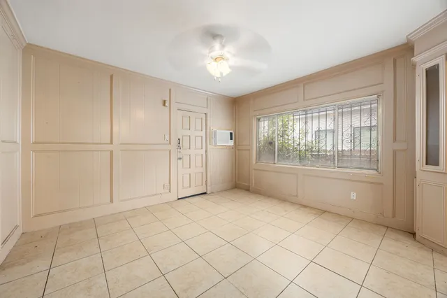 a view of an empty room with a kitchen
