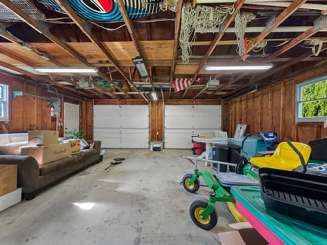 a utility room with furniture and a fan
