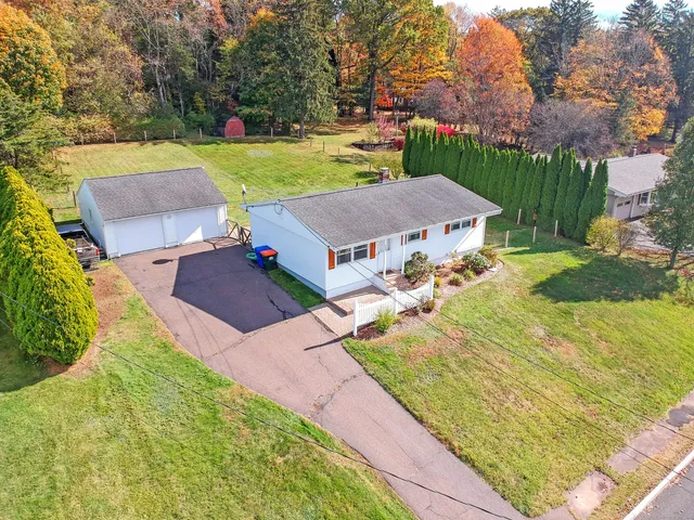 an aerial view of a house with yard swimming pool and outdoor seating