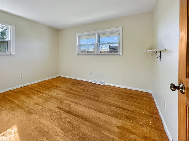 a view of a big room with wooden floor and closet