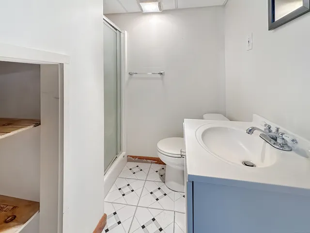 a bathroom with a sink toilet and shower