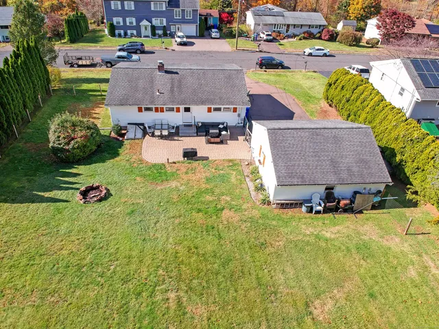 a aerial view of a house with swimming pool and garden