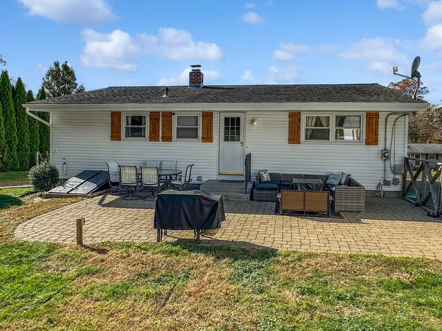 a view of a house with swimming pool and sitting area