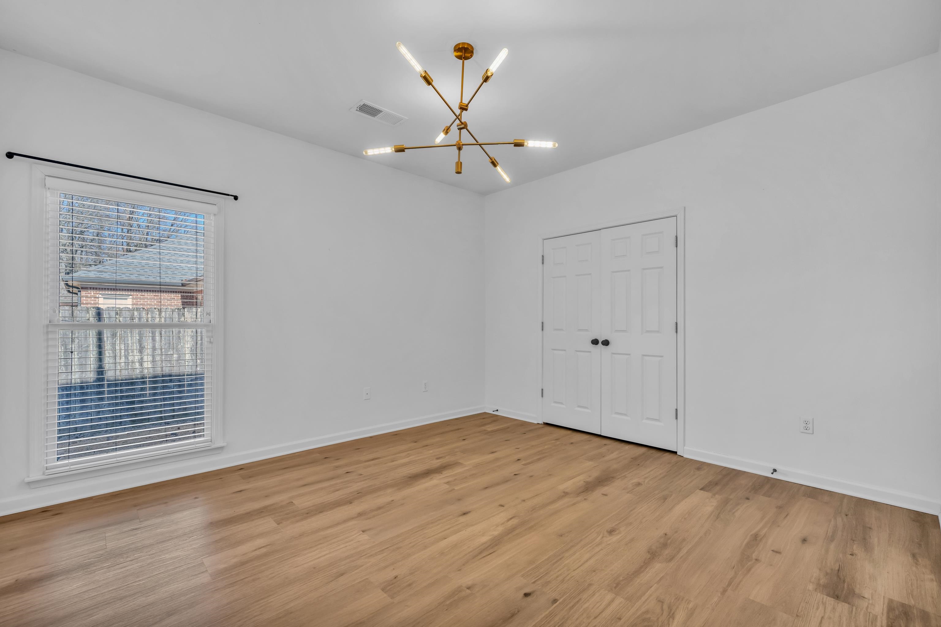 4305 Country Bridge Road Lakeland, TN 38002 - Photo 27 of 40 Spare room featuring an inviting chandelier and light hardwood / wood-style floors