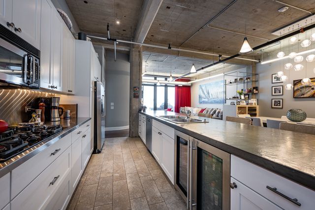 850 West Adams Street, Unit 6E Chicago, IL 60607 - Photo 4 of 14 a large kitchen with stainless steel appliances granite countertop a lot of counter space