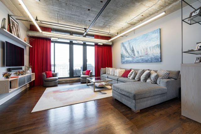850 West Adams Street, Unit 6E Chicago, IL 60607 - Photo 6 of 14 a living room with furniture and a flat screen tv
