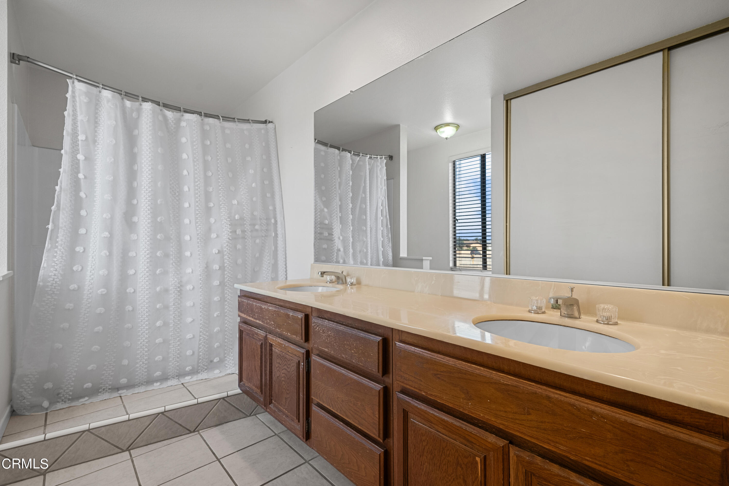 3450 Olds Road Oxnard, CA 93033 - Photo 23 of 30 a bathroom with a granite countertop sink and a mirror