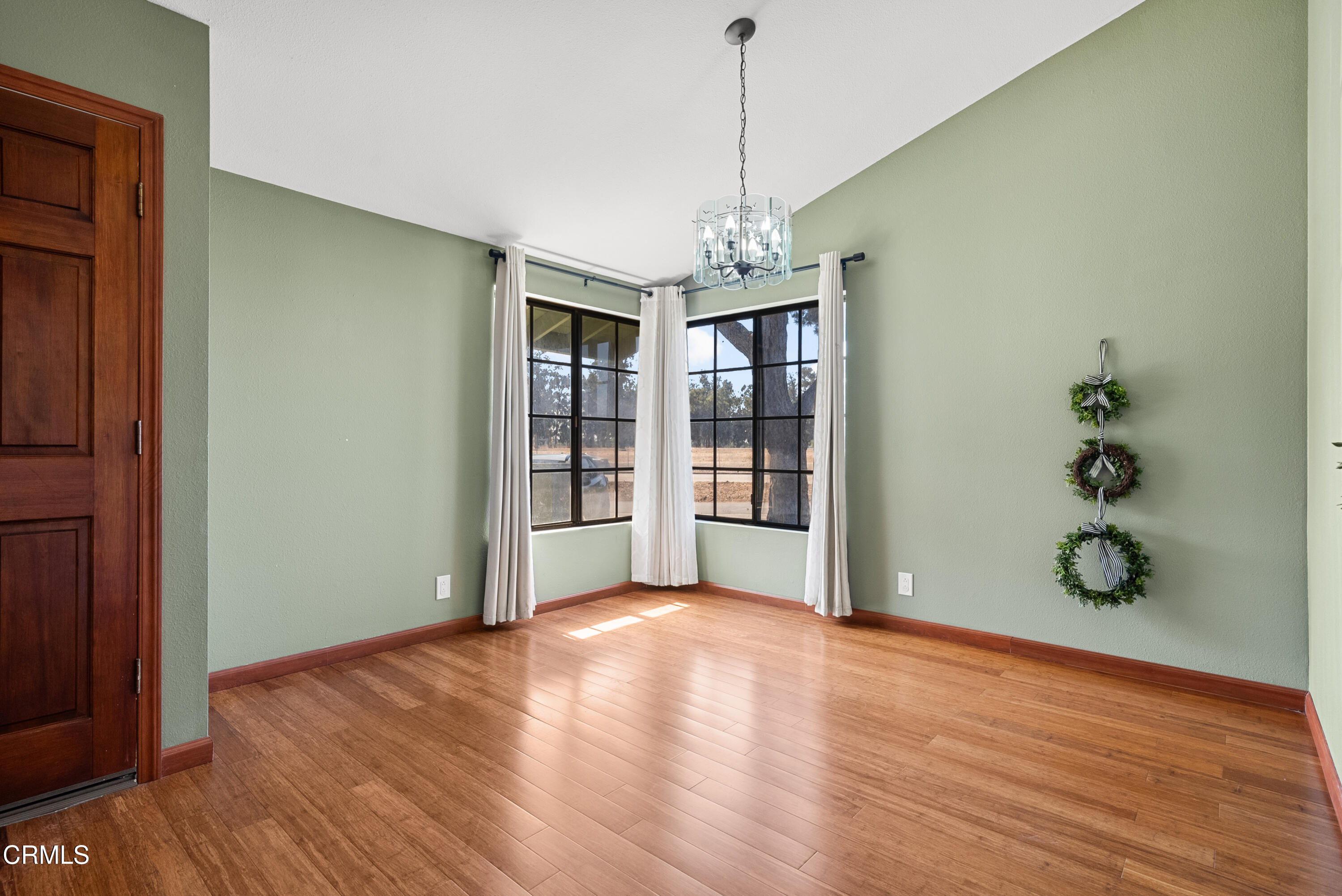 3450 Olds Road Oxnard, CA 93033 - Photo 7 of 30 a view of an empty room with a window and wooden floor